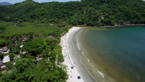 Aerial-overview-of-people-at-the-Barra-Do-Sahy-beach,-sunny-day-in-Brazil
