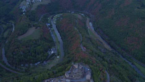 High-above-Bourscheid-castle-with-view-of-river-Sûre-in-Luxembourg,-aerial