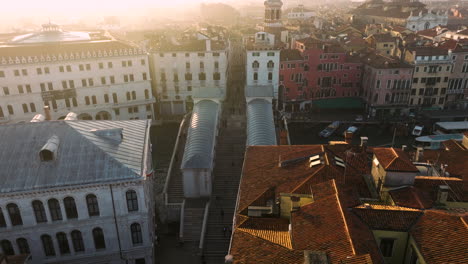 Draufsicht-Auf-Die-Rialtobrücke-Und-Weitere-Gebäude-In-Venedig,-Italien-Bei-Sonnenaufgang---Drohnenaufnahme-Aus-Der-Luft