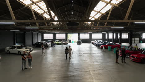 Establishing-aerial-view-from-warehouse-roofing-to-BMW-e30-old-school-classic-car-show-event