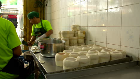 Thailand,-Bangkok---13-August-2022:-Men-workers-cutting-top-green-fresh-coconut-preparing-shell-for-coco-jelly,-famous-thai-dessert