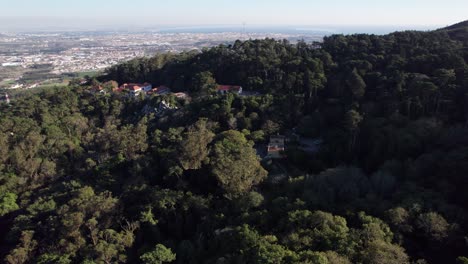 Drone-shot-revealing-the-town-of-Sintra-through-mountain,-Lisbon,-Portugal