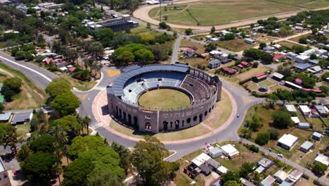 Aerial-orbit-of-the-arena-of-the-bullring-of-Colonia-del-Sacramento-in-Uruguay,-sunny-day