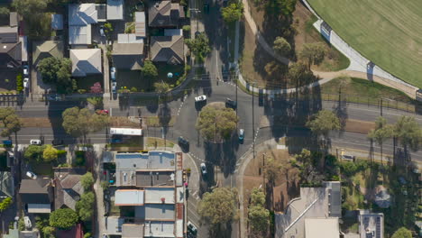 Hyperlapse-of-Australian-suburban-neighborhood-while-traffic-moves-through-round-about