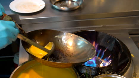 Thailand,-Bangkok---18-August-2022:-Chef-putting-oil-on-hot-pan,-adding-eggs-and-vegetables,-making-veggie-thai-omelette-in-restaurant