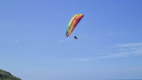 Paragliding-tandem-flight-scene-with-people-having-fun-in-the-sky-and-doing-extreme-sports-aerial-stunts-on-beaches