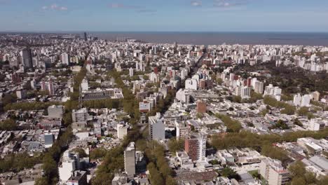 Aerial-flyover-Montevideo-Cityscape-with-Ocean-in-Background-during-sunny-day,Uruguay