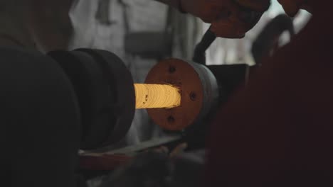 Blacksmith-Forging-Metal,-Hot-Spinning-Steel-On-A-Lathe-During-Manufacturing