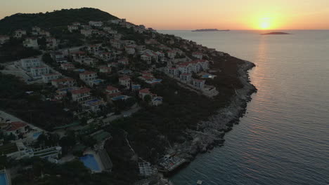 Drone-view-of-housing-at-beachside-at-sunset-time