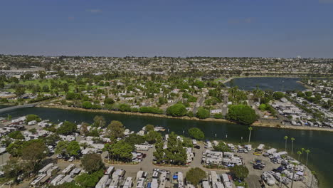 San-Diego-California-Aerial-v81-flyover-campland-on-the-bay-across-rose-inlet-towards-de-anza-cove,-caravan-camping-park-bayfront-sites-with-rvs-in-summer---Shot-with-Mavic-3-Cine---September-2022