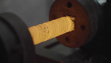 Closeup-Of-Forging-Metal-On-A-Lathe-During-Manufacturing-Process