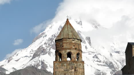 Kazbek-Mountain-And-Gergeti-Trinity-Church-In-Georgia---aerial-shot