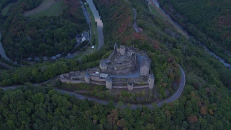 Historic-castle-landmark-on-forest-hill-in-Luxembourg,-Bourscheid,-aerial