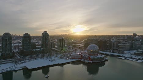 Vancouver-Canda-covered-in-winter-snow---Science-World-ASTC-building-Downtown-Area---Drone-Aerial-Sunset-Shot