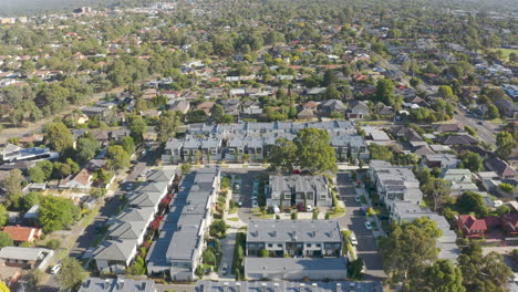 Aerial-flyover-of-modern-townhouses-among-existing-neighborhood