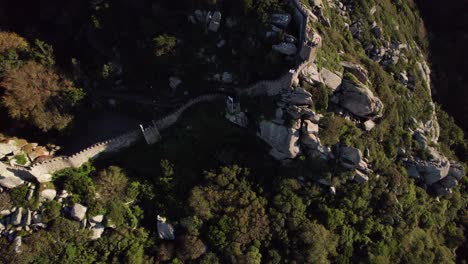 Aerial-tilt-up-shot-of-Castelo-Dos-Mouros-in-the-background,-Sintra,-Lisbon,-Portugal