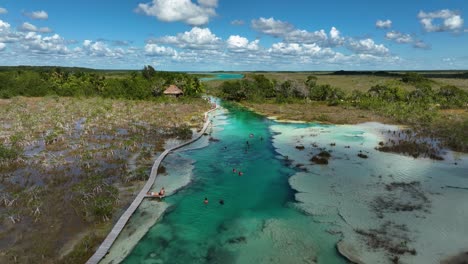 Aerial-view-over-tourists-enjoying-in-the-Rapidos-de-Bacalar,-in-sunny-Mexico