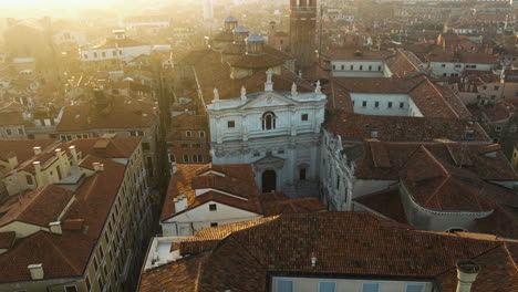 Old-Venetian-Roofs-At-Sunrise-In-Venice,-Italy---aerial-shot
