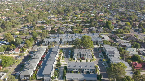 Aerial-reveal-of-contemporary-townhouse-building-development-amongst-the-suburban-sprawl