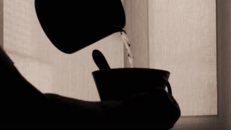 Silhouette-shadow-of-cup-kitchen-ware-pouring-water-into-a-mug-in-slow-motion
