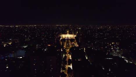 Aerial-dolly-in-view-of-Buenos-Aires-latin-city-at-night-time-illuminated-by-city-lights