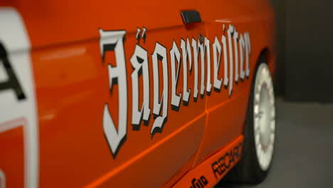 Orange-Jägermeister-sponsor-branding-on-BMW-e30-vehicle-at-Barcelona-fan-meeting-event