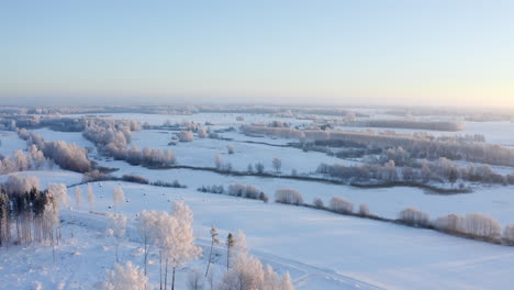 Flying-over-a-calm-rural-landscape-in-winter