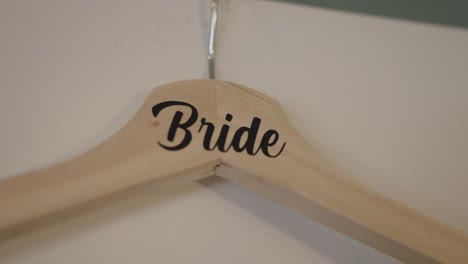 Close-up-of-a-clothing-hanger-with-"Bridge"-printed-for-hanging-wedding-dress