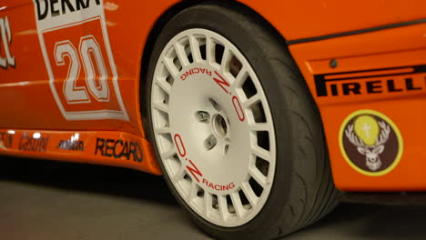 Close-up-of-wheel-or-orange-sport-BMW-e30-car-vehicle-during-fan-meeting
