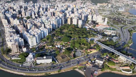 Aerial-drone-scene-at-high-altitude-of-the-center-of-Florianópolis-urban-center-big-capital-with-many-buildings-streets-and-Hercilio-Luz-bridge,-urban-center-seen-from-above-capital-santa-catarina