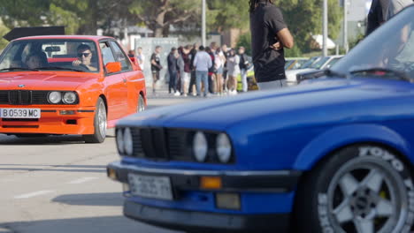 Car-show,-fans-driving-fancy-BMW-e30-vintage-cars,-slow-motion,-static,-day