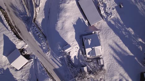 pushing-in-top-down-view-of-snowy-Chalets-in-Grindelwald-in-Swiss-Alps