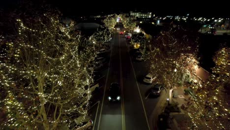 Christmas-Lights-at-Night-on-Trees-and-Street-in-Neighborhood-of-Santa-Clarita,-Los-Angeles-CA,-Drone-Aerial-View