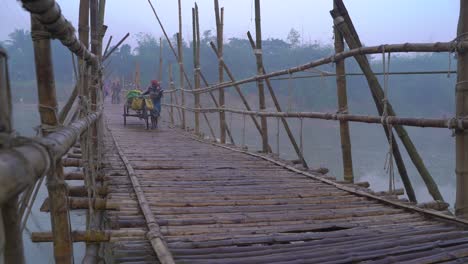 In-winter,-a-bamboo-bridge-is-constructed-on-the-river-due-to-the-water-shortage-and-the-people-of-the-upper-and-over-the-road-pass-through-it