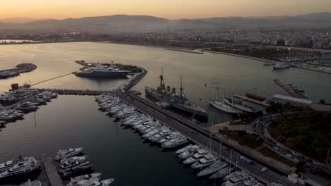 A-captivating-drone-shot-of-the-Floisvos-Marina-and-Averof-Battleship-during-a-beautiful-sunset