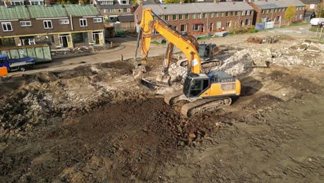 Aerial-View-Of-Digger-Levelling-Ground-For-Construction-At-Hendrik-Ido-Ambacht