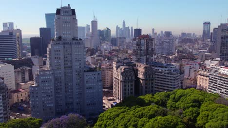 Aerial-view-establishing-boom-up-buildings-in-Buenos-Aires,-Edificio-Kavanagh-in-the-Retiro-neighborhood-on-a-sunny-day