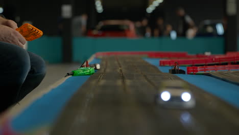 Watching-BMW-Scalextric-scale-race-track-competition-at-Barcelona-car-show