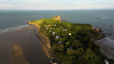Aerial-flying-backwards-from-Huriawa-Historic-Site-during-golden-hour