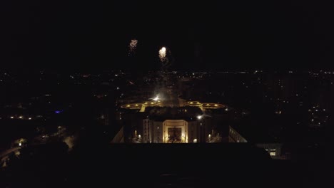 Aerial-shot-of-fireworks-on-top-of-a-roof-during-the-night