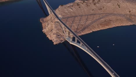 Above-Krk-bridge-in-Croatia-crossing-blue-Adriatic-sea,-Krcki-Most