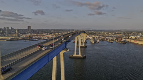 San-Diego-California-Aerial-v93-cinematic-low-flyover-bay-along-side-coronado-bridge-capturing-commuting-traffic-motions-and-downtown-cityscape-at-sunset---Shot-with-Mavic-3-Cine---September-2022