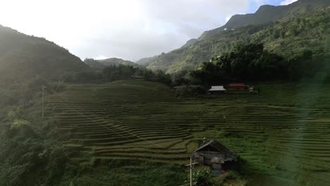 Magical-light-in-aerial-shot-of-rice-fields-deep-in-the-mountains-of-Sapa,-Vietnam