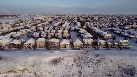 Aerial-shot-of-winter-community-with-houses-covered-with-snow