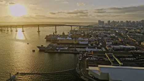 San-Diego-California-Aerial-v98-low-flyover-indian-point-capturing-ship-building-and-repair-sites-with-coronado-bridge-and-cityscape-view-at-sunset---Shot-with-Mavic-3-Cine---September-2022