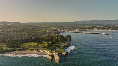 Santa-Cruz-California-Aerial-v3-cinematic-drone-fly-around-lighthouse-point-capturing-state-beach,-neighborhood-town-and-municipal-wharf-at-sunset-golden-hour---Shot-with-Mavic-3-Cine---May-2022