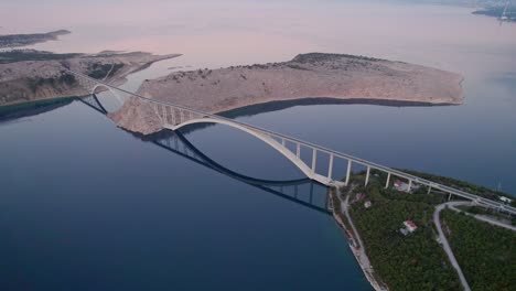 Krk-double-arch-bridge-connecting-mainland-Croatia-and-island,-aerial