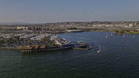 San-Diego-California-Aerial-v92-low-flyover-bay-around-harbor-island-capturing-airport-airfield,-downtown-cityscape-and-cruise-ship-sailing-on-the-water---Shot-with-Mavic-3-Cine---September-2022