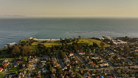 Santa-Cruz-California-Aerial-v6-drone-flyover-residential-neighborhood-capturing-lighthouse-field-state-beach-and-park-and-vista-seascape-view-at-sunset-golden-hour---Shot-with-Mavic-3-Cine---May-2022