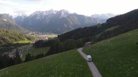 Green-hills-and-serpentine-in-Passo-Gardena,-Dolomites,-aerial-view